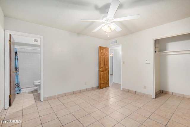 6430 W Thomas Rd, Phoenix, AZ 85033 - unfurnished bedroom featuring light tile patterned floors, a closet, a ceiling fan, and baseboards