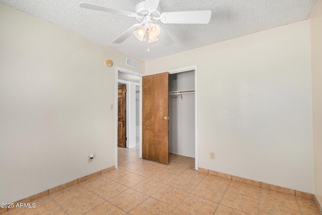6430 W Thomas Rd, Phoenix, AZ 85033 - unfurnished bedroom featuring a textured ceiling, baseboards, a closet, light tile patterned flooring, and ceiling fan