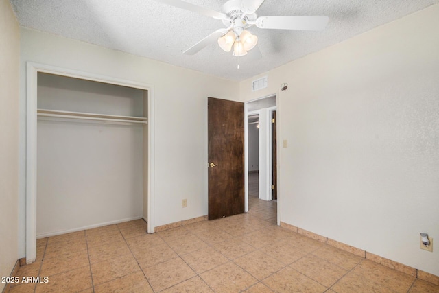 6430 W Thomas Rd, Phoenix, AZ 85033 - unfurnished bedroom featuring a textured ceiling, a closet, baseboards, light tile patterned floors, and ceiling fan