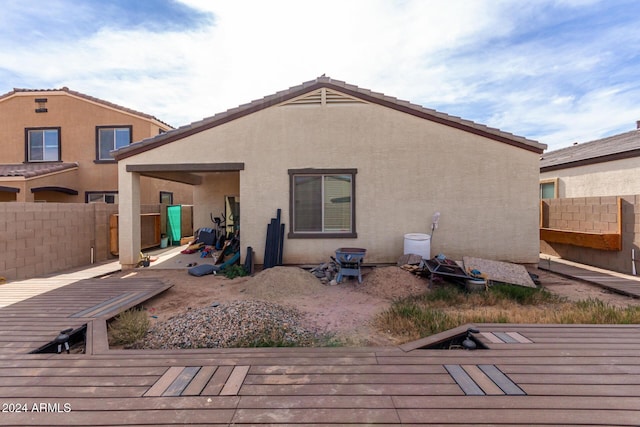 back of property with a wooden deck