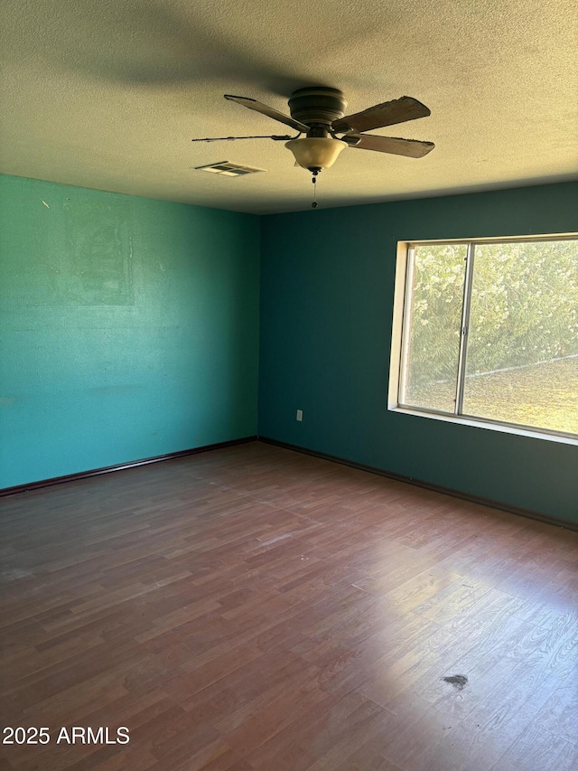 5542 W Monte Cristo Ave, Glendale, AZ 85306 - spare room featuring wood finished floors, a ceiling fan, and a textured ceiling