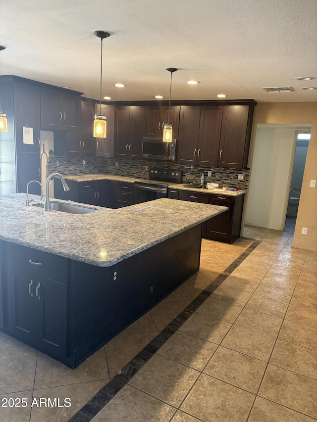 5542 W Monte Cristo Ave, Glendale, AZ 85306 - kitchen featuring black range with electric cooktop, stainless steel microwave, a sink, tasteful backsplash, and light stone counters