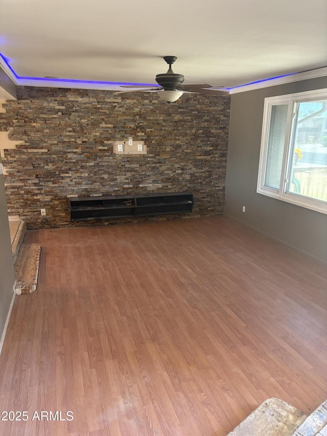 5542 W Monte Cristo Ave, Glendale, AZ 85306 - unfurnished living room featuring a ceiling fan and wood finished floors
