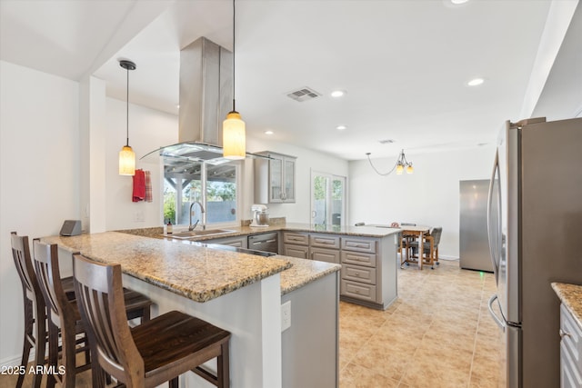 kitchen featuring visible vents, gray cabinetry, a sink, appliances with stainless steel finishes, and a peninsula