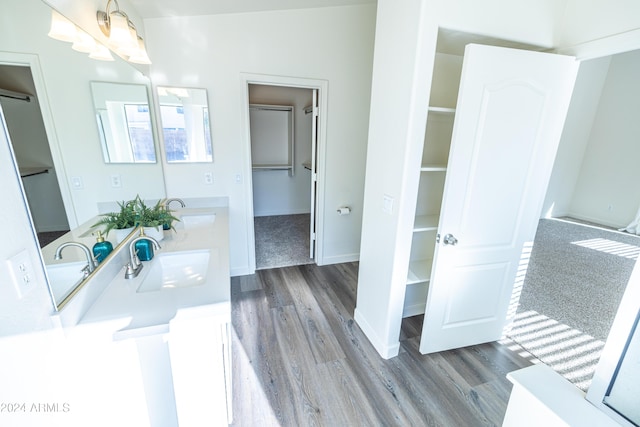 bathroom featuring hardwood / wood-style floors, vanity, and a notable chandelier