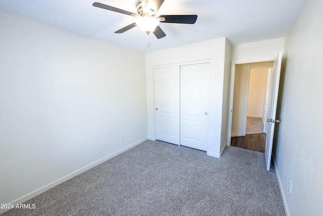 unfurnished bedroom with carpet, a closet, and ceiling fan