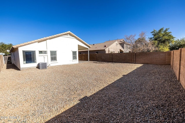 back of house featuring central AC