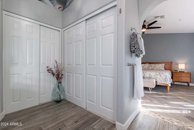 bedroom with ceiling fan, vaulted ceiling, and wood-type flooring