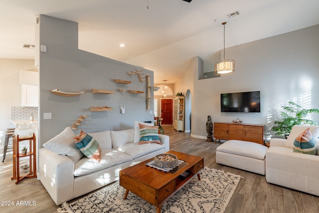 living room with high vaulted ceiling, hardwood / wood-style floors, and ceiling fan