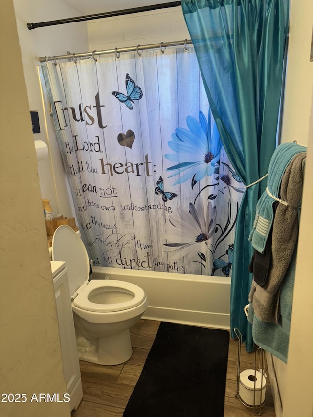 bathroom featuring toilet, wood-type flooring, and shower / bathtub combination with curtain