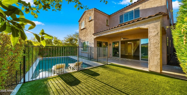 view of swimming pool with ceiling fan, fence, a patio area, and a fenced in pool