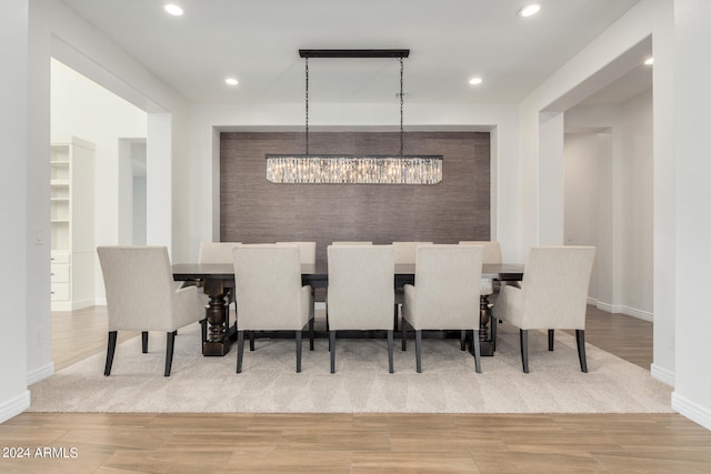 dining area featuring an inviting chandelier and hardwood / wood-style flooring