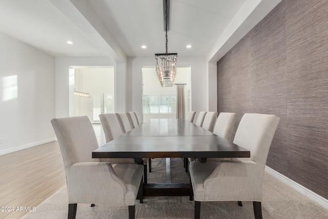 dining space featuring light hardwood / wood-style flooring and a notable chandelier