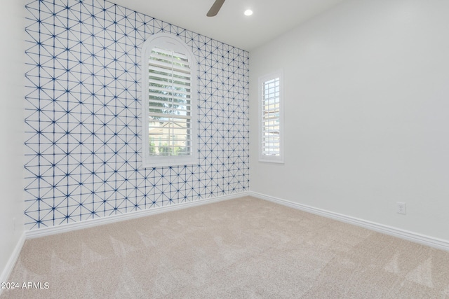 carpeted empty room with ceiling fan