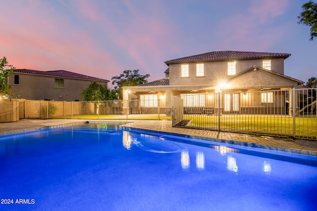 view of pool at dusk