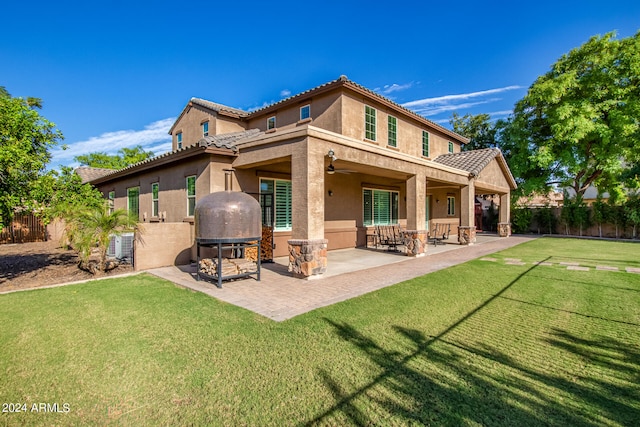 rear view of property featuring a patio, cooling unit, ceiling fan, and a yard