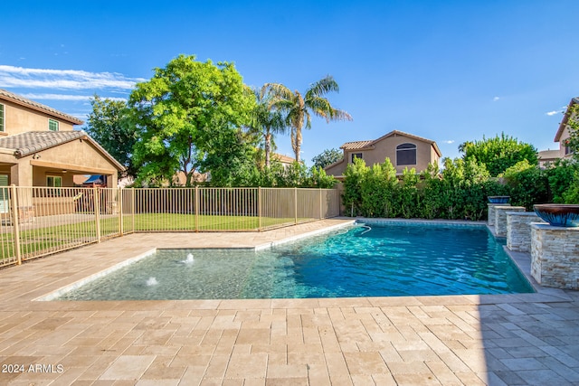 view of swimming pool with a yard, a patio area, and pool water feature