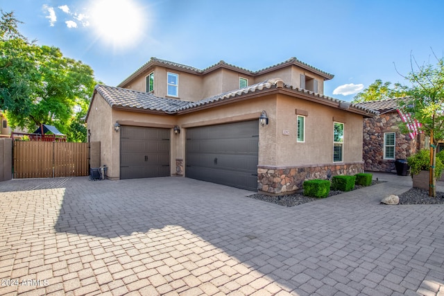 mediterranean / spanish home featuring a garage