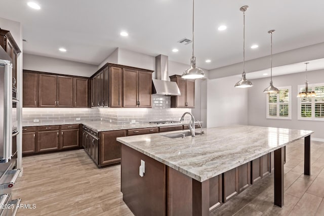 2027 E Ln Costa Ct, Gilbert, AZ 85298 - kitchen featuring wall chimney exhaust hood, a sink, tasteful backsplash, light stone countertops, and recessed lighting