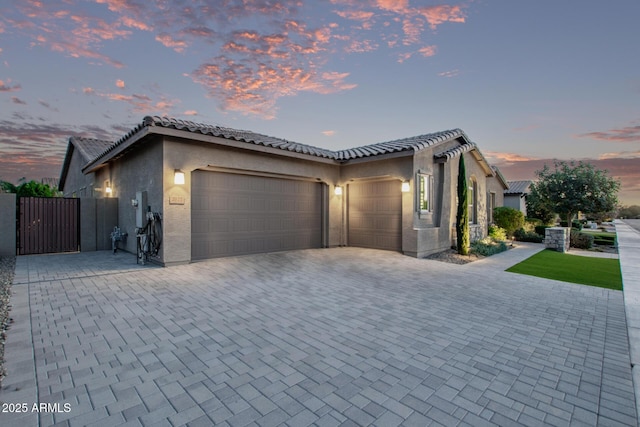 2027 E Ln Costa Ct, Gilbert, AZ 85298 - view of front facade with an attached garage, a gate, stucco siding, decorative driveway, and a tile roof