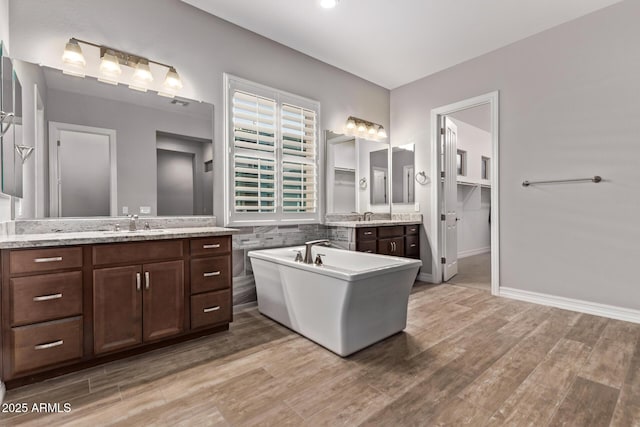 2027 E Ln Costa Ct, Gilbert, AZ 85298 - bathroom with wood finished floors, a soaking tub, and two vanities