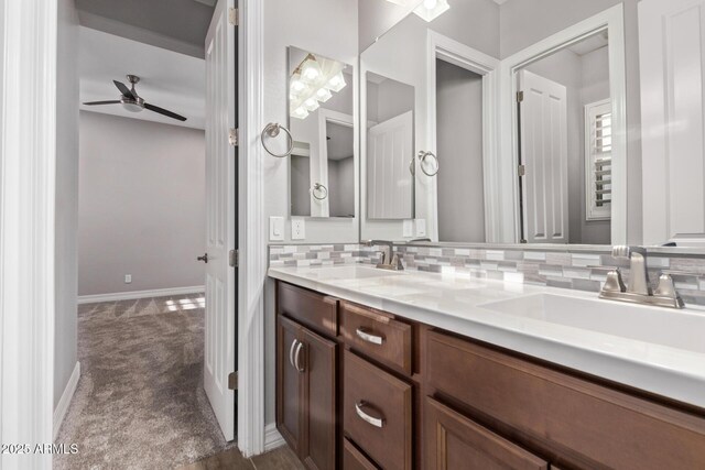 2027 E Ln Costa Ct, Gilbert, AZ 85298 - bathroom featuring a ceiling fan, baseboards, double vanity, and tasteful backsplash