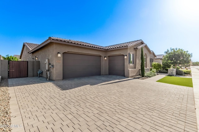 2027 E Ln Costa Ct, Gilbert, AZ 85298 - view of front facade with a garage, a gate, decorative driveway, stucco siding, and a tiled roof