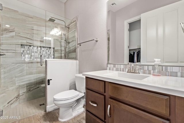 2027 E Ln Costa Ct, Gilbert, AZ 85298 - full bathroom featuring a shower stall, toilet, vanity, and backsplash