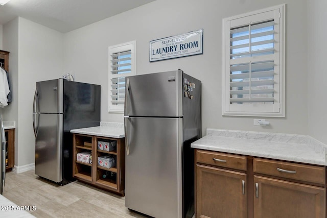 2027 E Ln Costa Ct, Gilbert, AZ 85298 - kitchen with freestanding refrigerator, healthy amount of natural light, and light wood-style floors