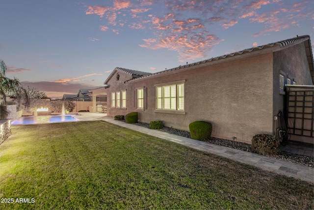 2027 E Ln Costa Ct, Gilbert, AZ 85298 - back of property at dusk featuring a patio and stucco siding