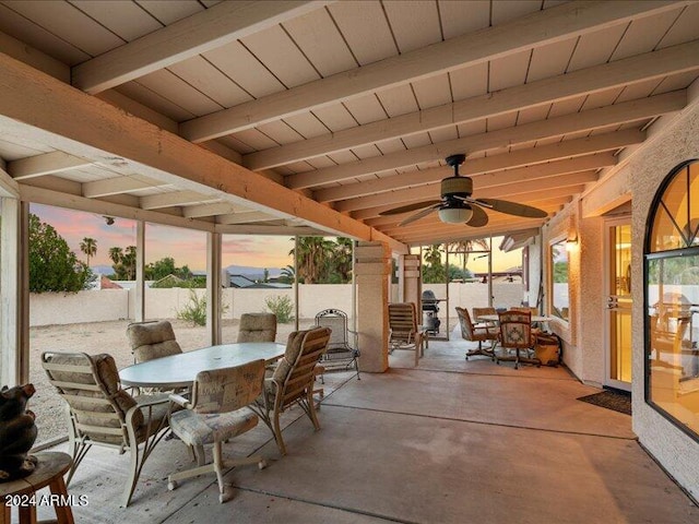 patio terrace at dusk featuring ceiling fan