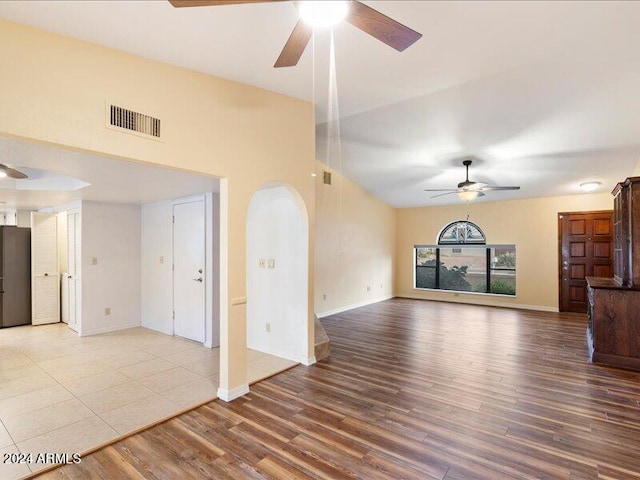 unfurnished living room featuring hardwood / wood-style floors and ceiling fan