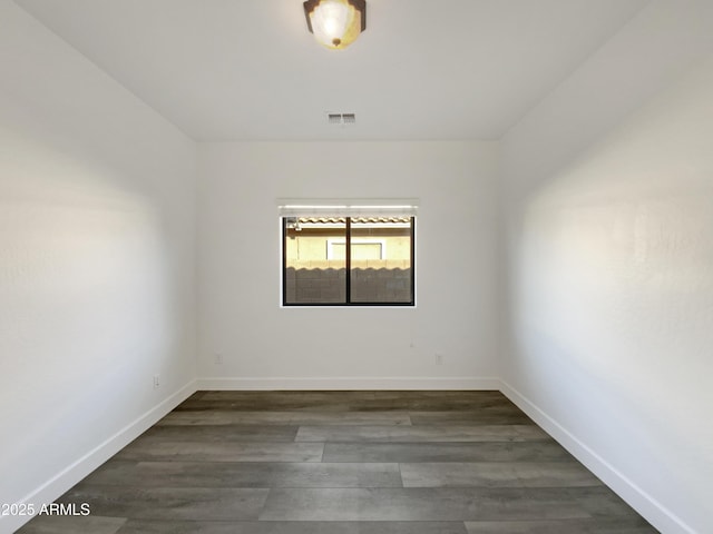 unfurnished room with dark hardwood / wood-style floors