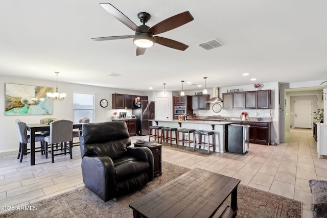 living room featuring ceiling fan with notable chandelier