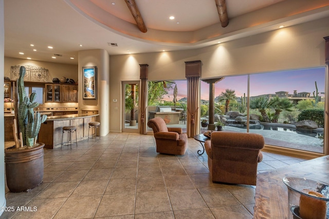 living room featuring recessed lighting, beamed ceiling, and tile patterned flooring