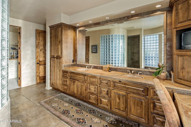 bathroom with tile patterned floors, recessed lighting, and double vanity