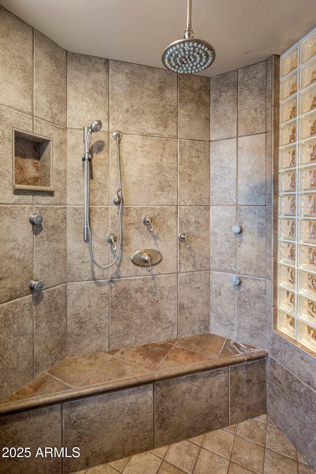 bathroom with tiled shower