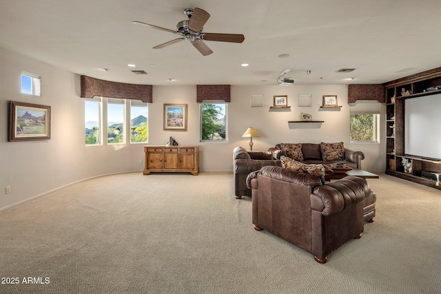 living area with carpet, healthy amount of natural light, a ceiling fan, recessed lighting, and baseboards