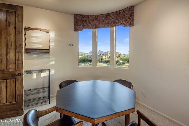 dining room with carpet and baseboards