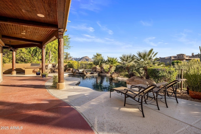 view of pool with a patio area and a pool with connected hot tub