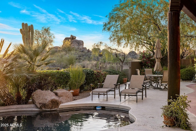 surrounding community with a patio and fence