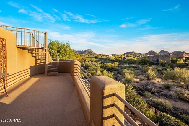 balcony with stairs and a mountain view