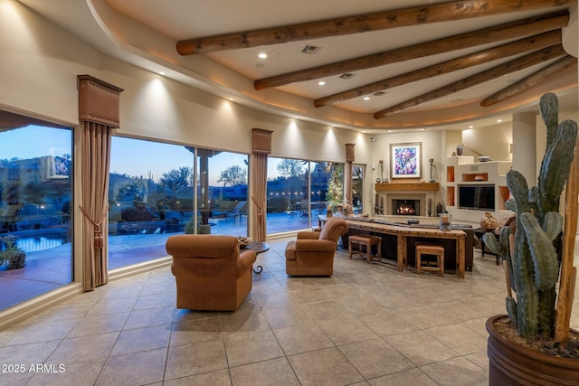 living area with light tile patterned floors, beam ceiling, recessed lighting, and a warm lit fireplace