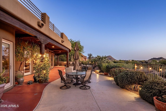 view of patio featuring outdoor dining space and fence