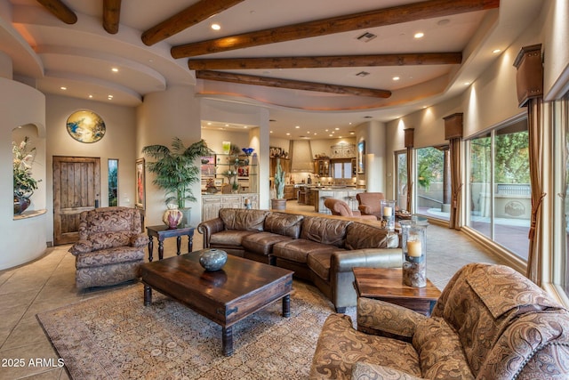 living room featuring light tile patterned flooring, beam ceiling, and recessed lighting