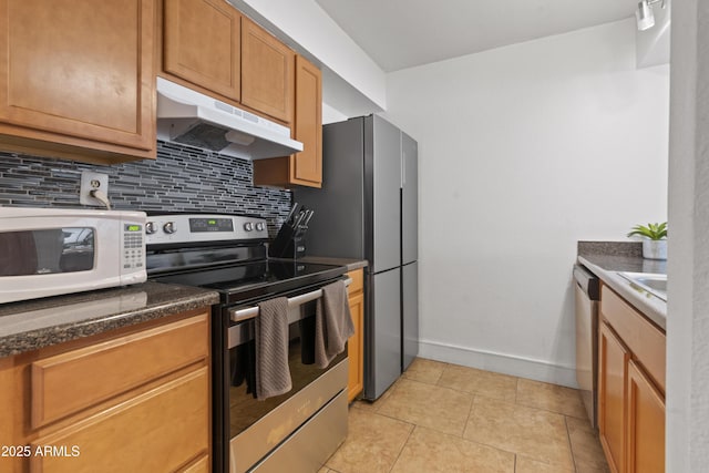 kitchen with decorative backsplash, sink, light tile patterned floors, and stainless steel appliances