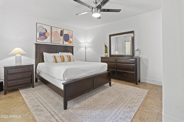 bedroom featuring a textured ceiling, ceiling fan, and light tile patterned floors