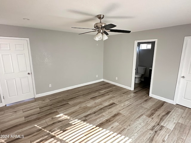 unfurnished room featuring ceiling fan and hardwood / wood-style floors