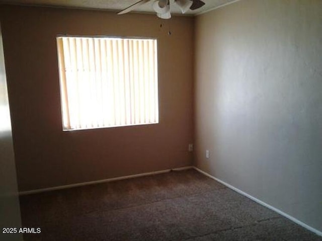 carpeted empty room featuring ceiling fan