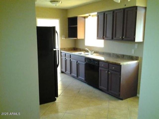 kitchen with black appliances, light tile patterned floors, and sink